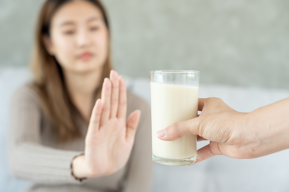 Milk allergens, Sick sad unhealthy ill allergic woman, runny stuffy sore nose suffer from intolerance allergy trigger symptoms. abdominal pain, allergens, nut protein, rash, death, food allergy