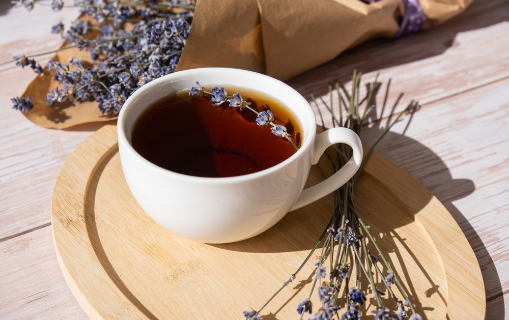 Healthy homemade cup of lavender tea. Organic natural home grown herb for teas. White cup of tea with dried lavender flowers. Healthy living wellbeing