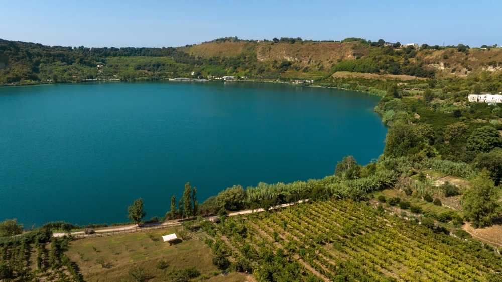 Aerial view of the lakeside of Lago d'Averno located in Pozzuoli, near Naples, Italy. It is a volcanic lake located in the Campi Flegrei. The lake is approximately circular.