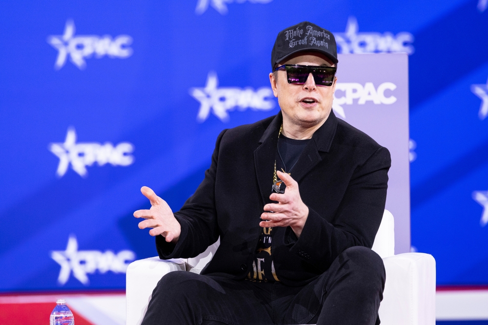 NATIONAL HARBOR, MD, USA — February 20 2025: Elon Musk speaks with Newsmax Host Rob Schmitt on day 1 of the 2025 Conservative Political Action Conference.