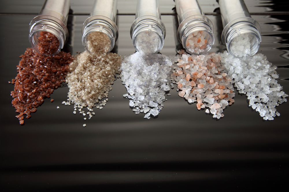 Collection of different types of salt on black background