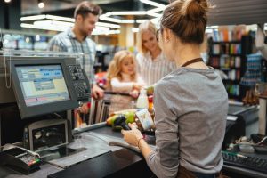 Is $140,000 the New Poverty Line for American Families? family at check out at grocery store