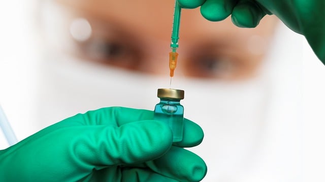 doctor drawing vaccine with syringe