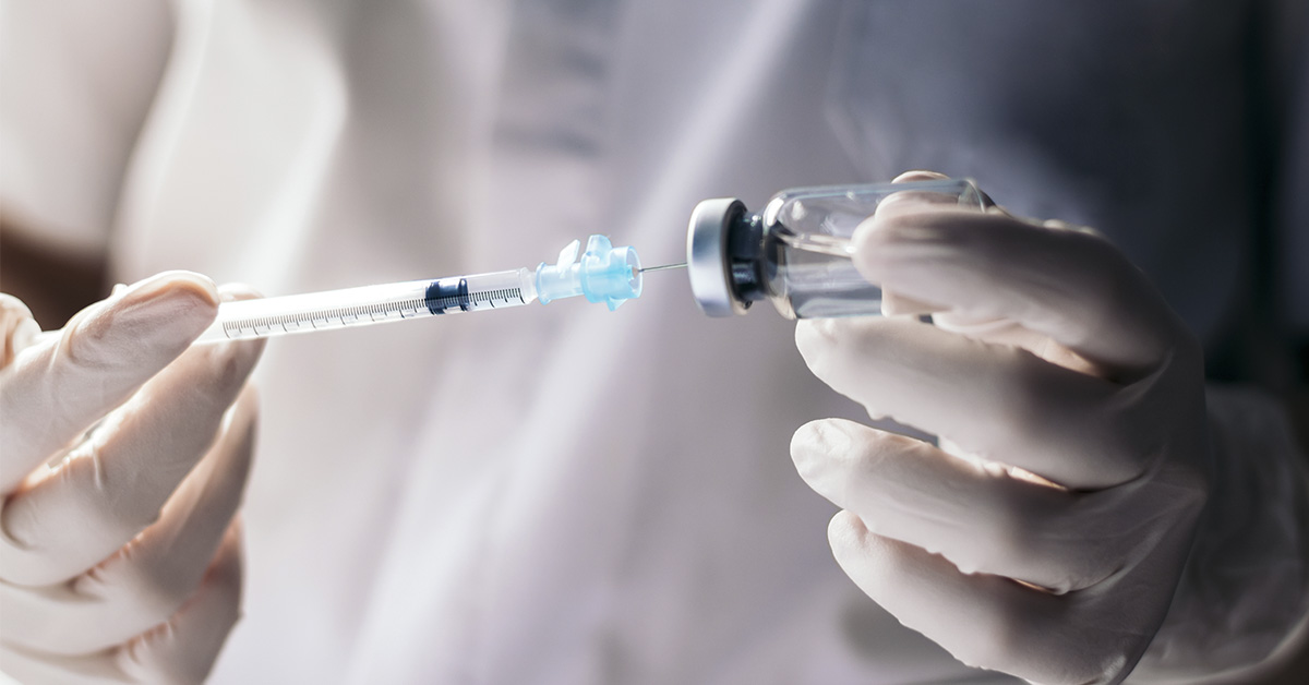 vaccine being extracted from small bottle. Vaccination concept