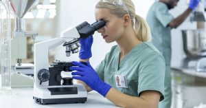 health professional or scientists using microscope