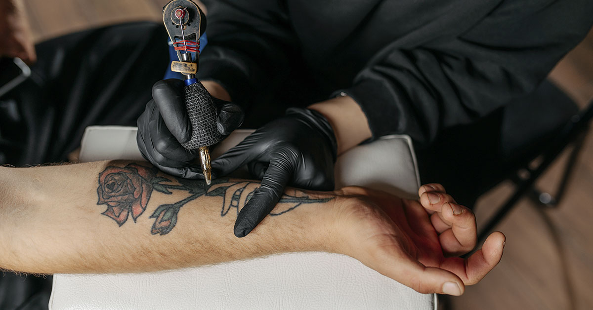 person getting tattoo on their arm