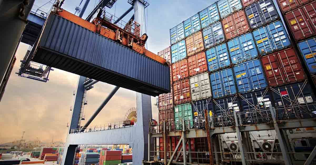 shipping containers being moved around at a shipping and receiving yard. Global trade concept