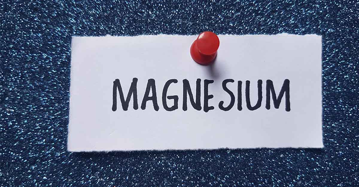 Magnesium printed on small piece of paper pinned to blue wall