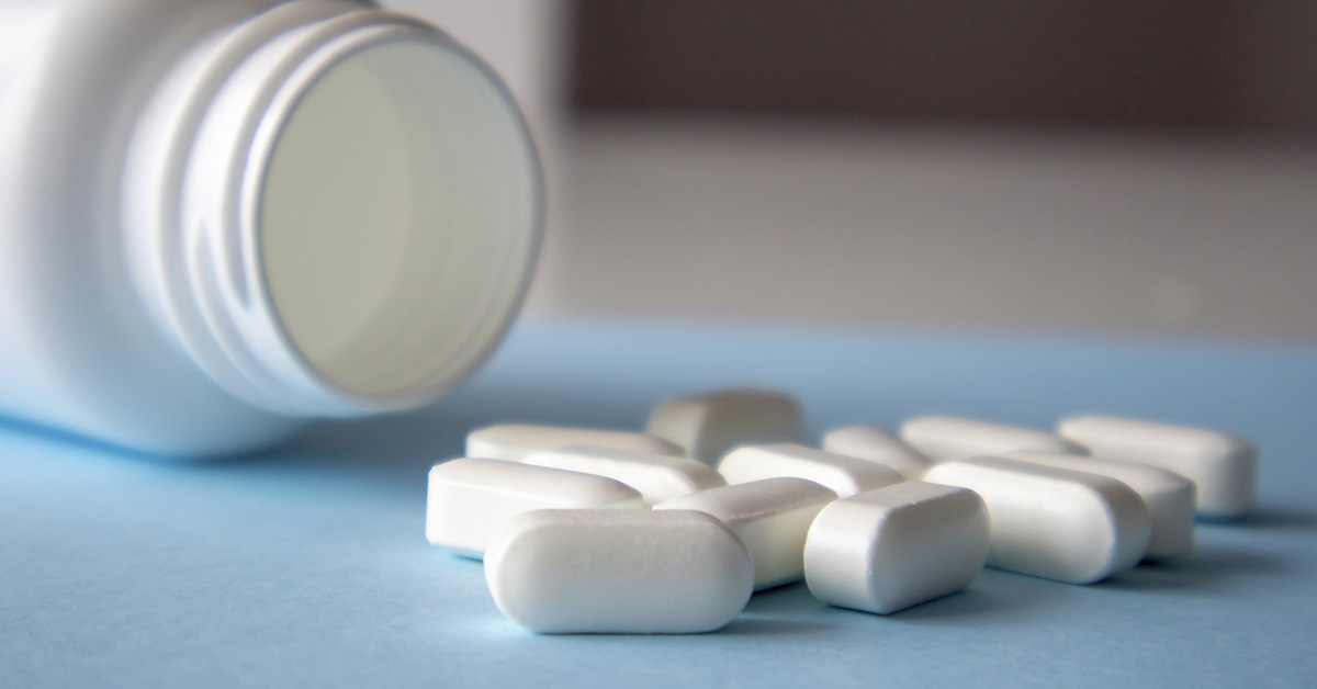 white pills spilled from bottle