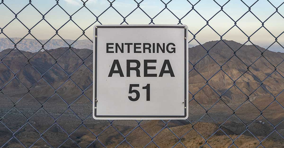 sign on fence reading "Entering Area 51"
