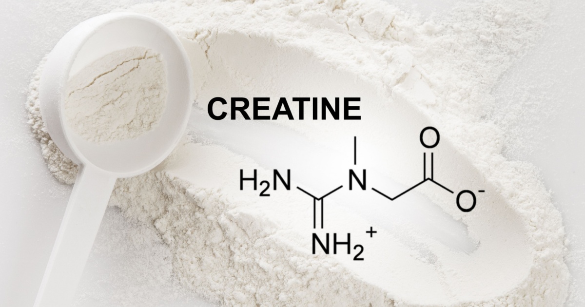 Closeup of scoop with creatine monohydrate supplement and chemical formula