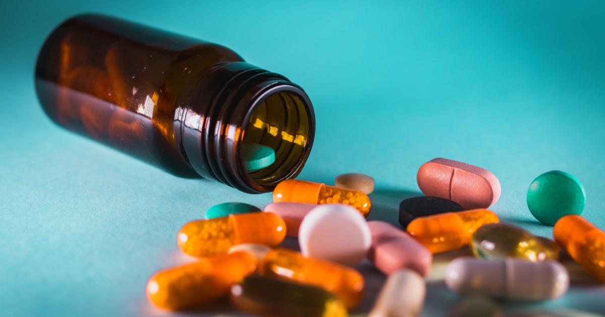 Medicine bottle with spilled pills, drugs, vitamins and dietary supplements