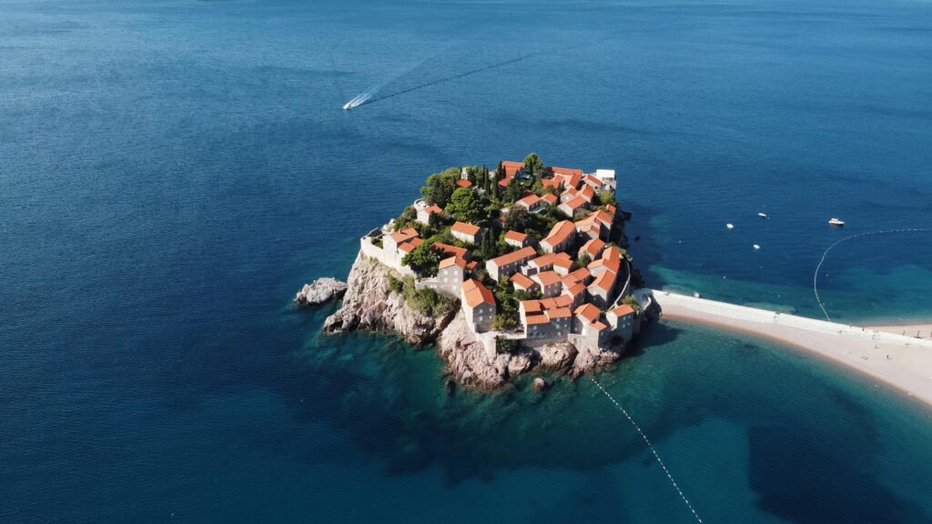 An aerial view of a small island with a church on it

