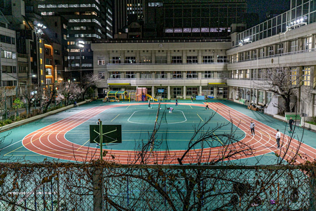 Urban School Playground at Night with Track