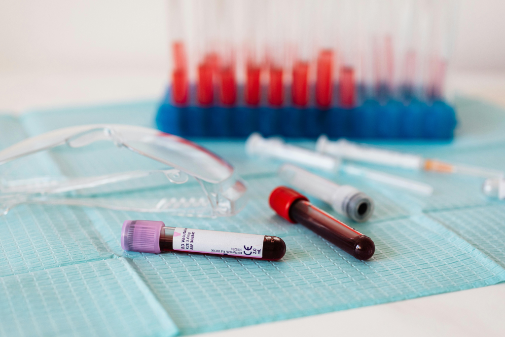 Blood collection tubes and medical equipment on a laboratory mat.