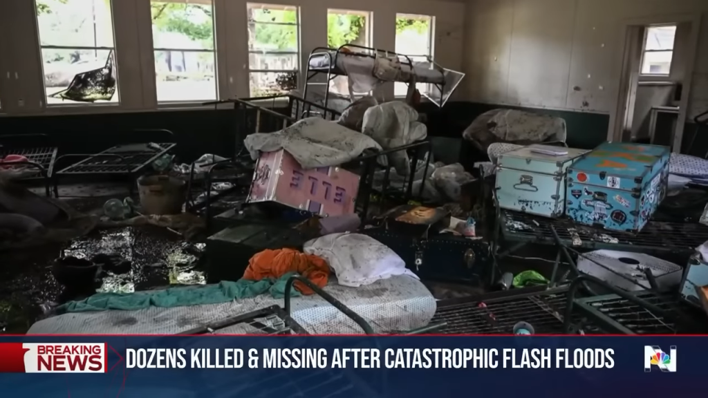 Interior flood damage showing scattered furniture, belongings, and debris throughout a building after flash flooding.