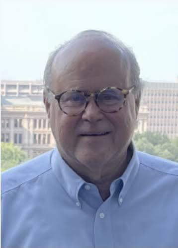Dick Eastland, owner of Camp Mystic, wearing glasses and blue shirt.