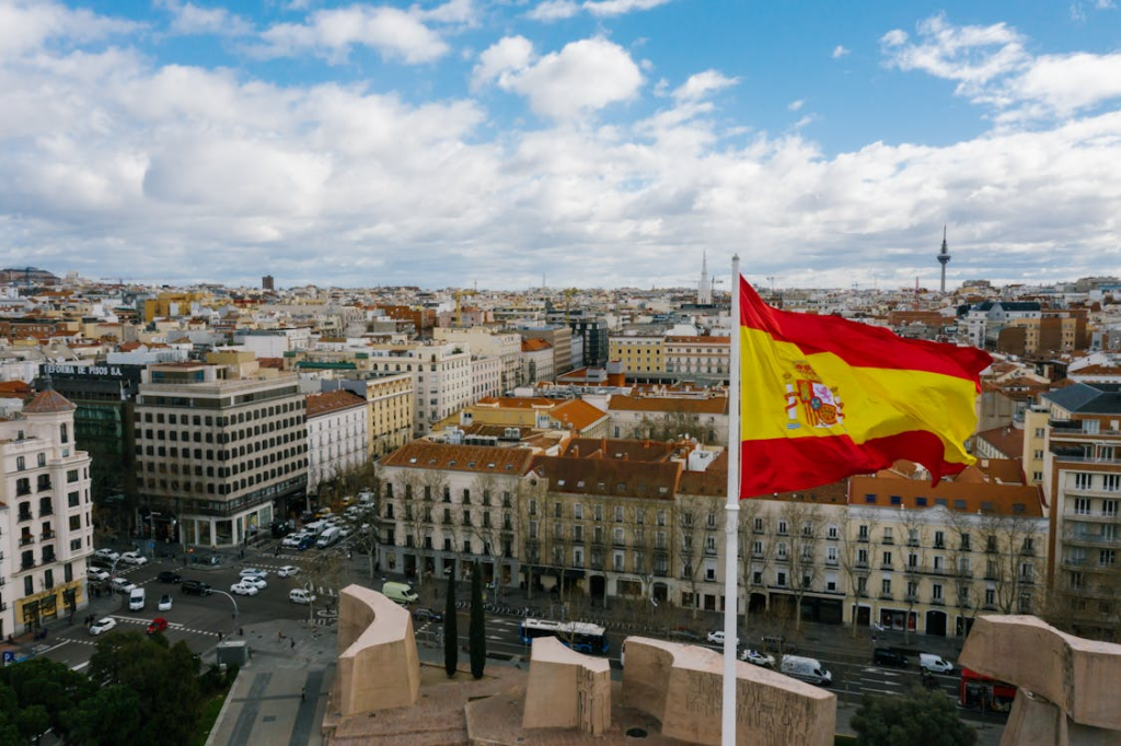 Spanish national flag against cityscape
