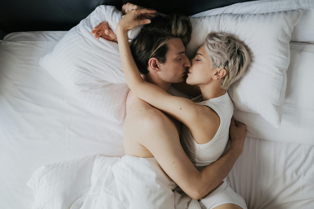 Intimate couple lying together, representing the connection between sexual activity and UTI risk.
