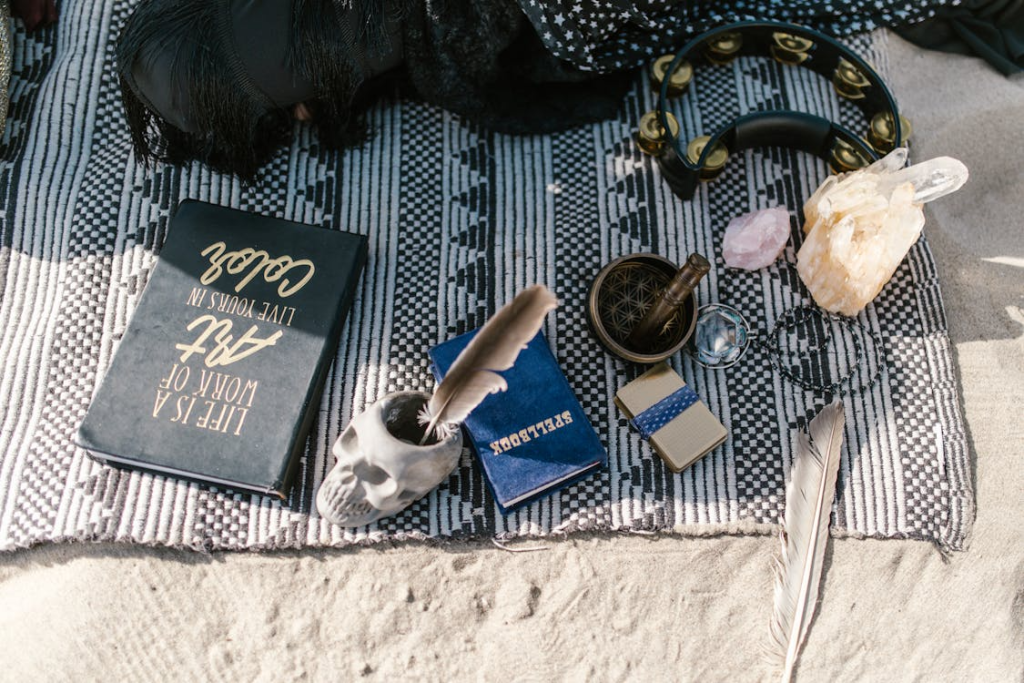 Blue and White Book Beside Blue and White Ceramic Mug on White Textile

