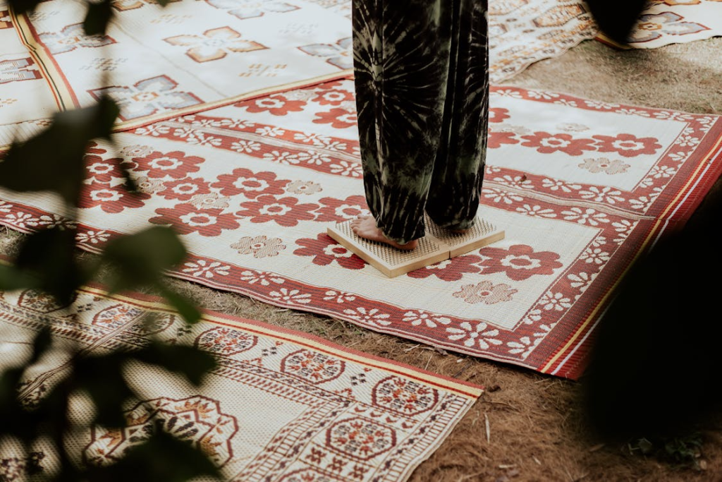 Person Standing on an Acupressure Mat Lying on a Rug
