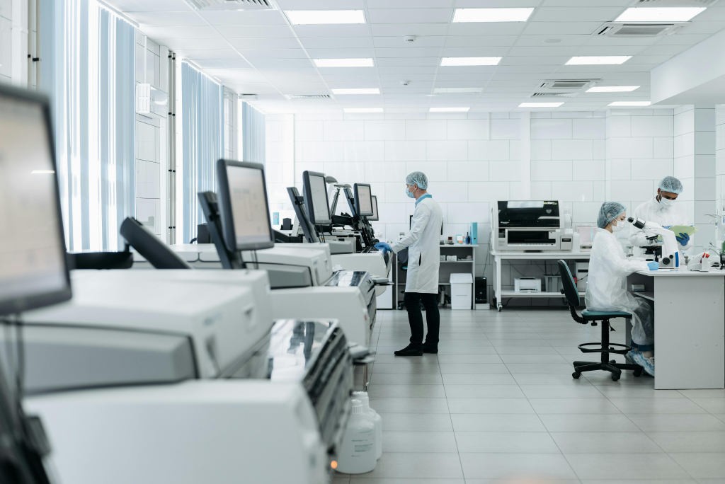 Modern sterile laboratory with researchers in white coats operating advanced scientific equipment used for behavioral research.