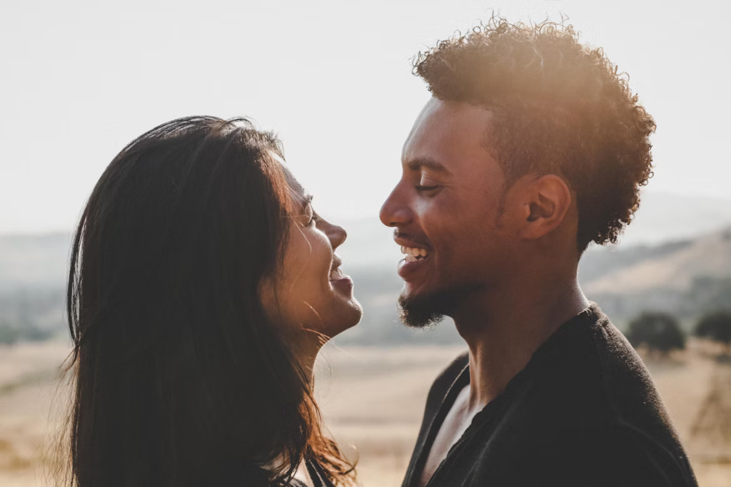 Smiling couple gazing at each other in warm golden light, showing the emotional connections researchers are studying.