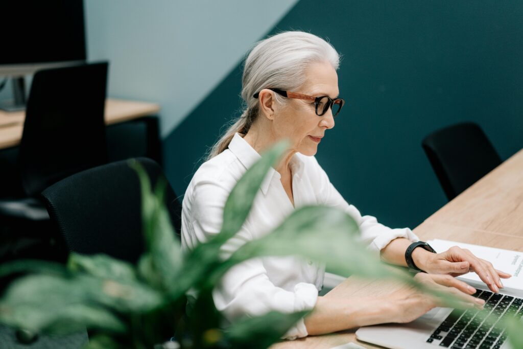 Woman Using Laptop Inside an Office 