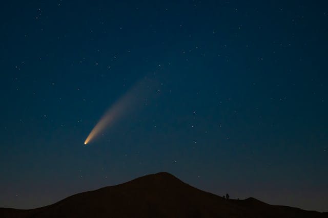 comet flying over a mountain