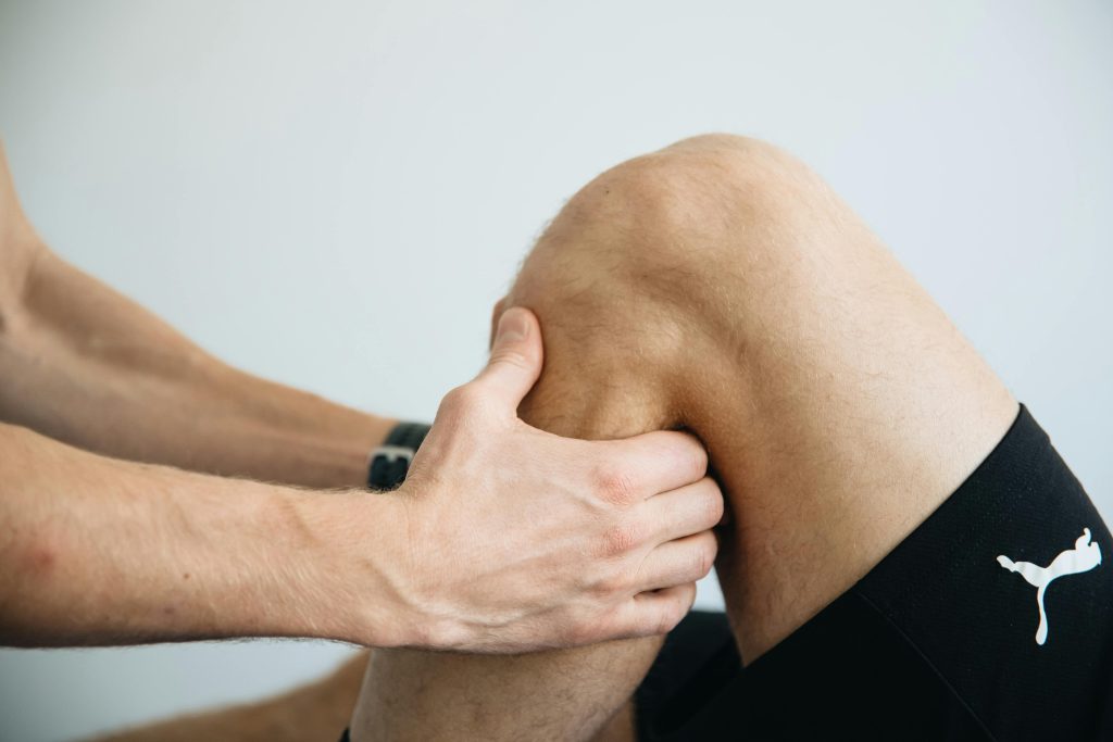 Physiotherapist Massaging Knee
