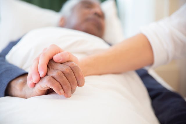 man sick in hospital bed