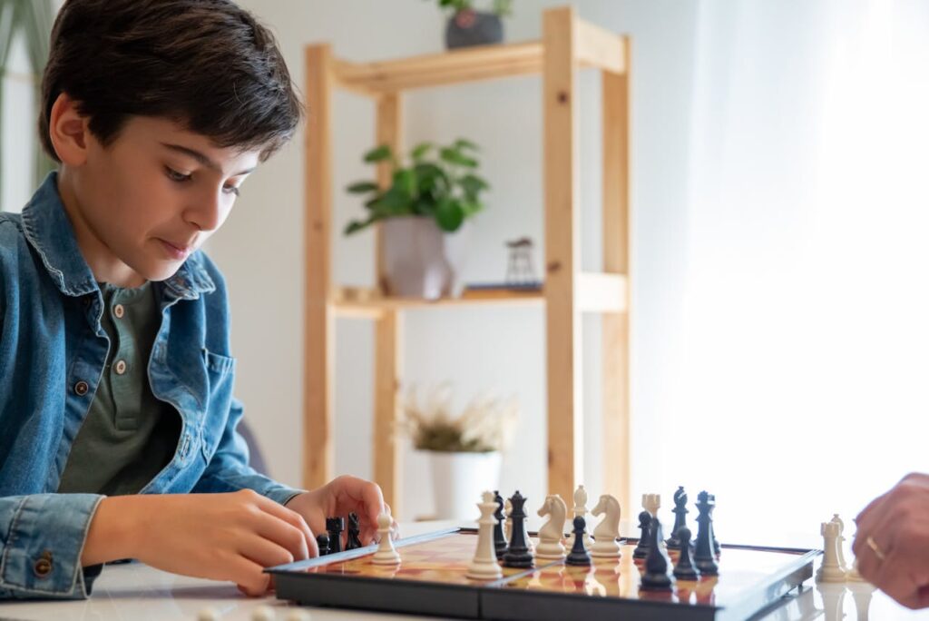 Boy in Denim Jacket Playing Chess
