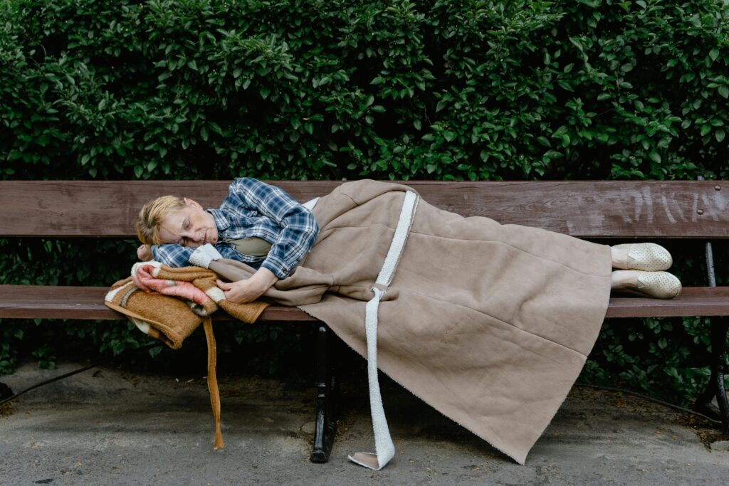 Woman Sleeping on a Wooden Bench
