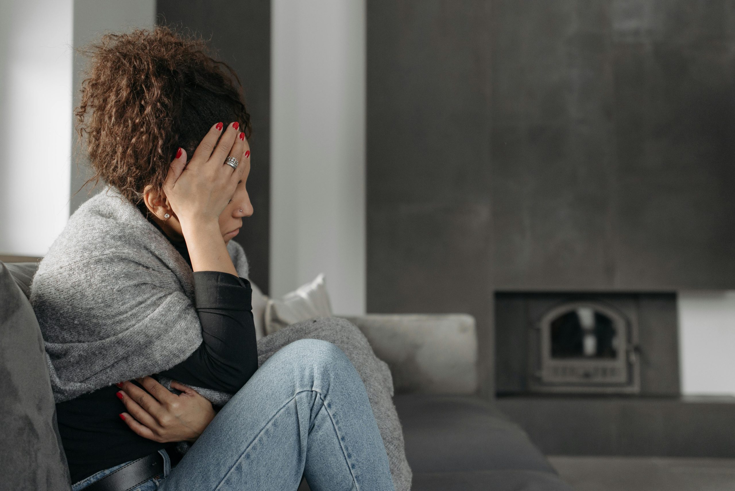 Woman experiencing discomfort, showing serious symptoms requiring emergency medical attention.