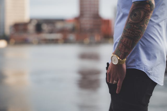 man with tattoos on his arms
