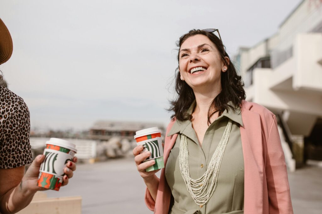 Woman smiling holding a plastic cup