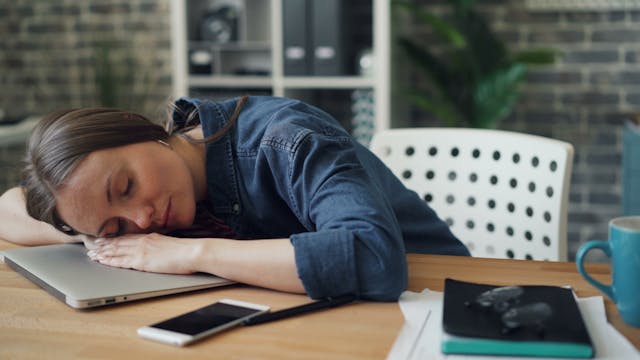 woman sleeping at desk