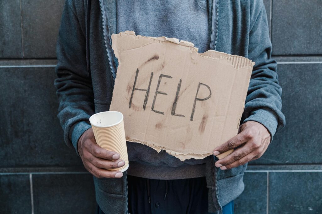 Man Holding Placard Saying Help
