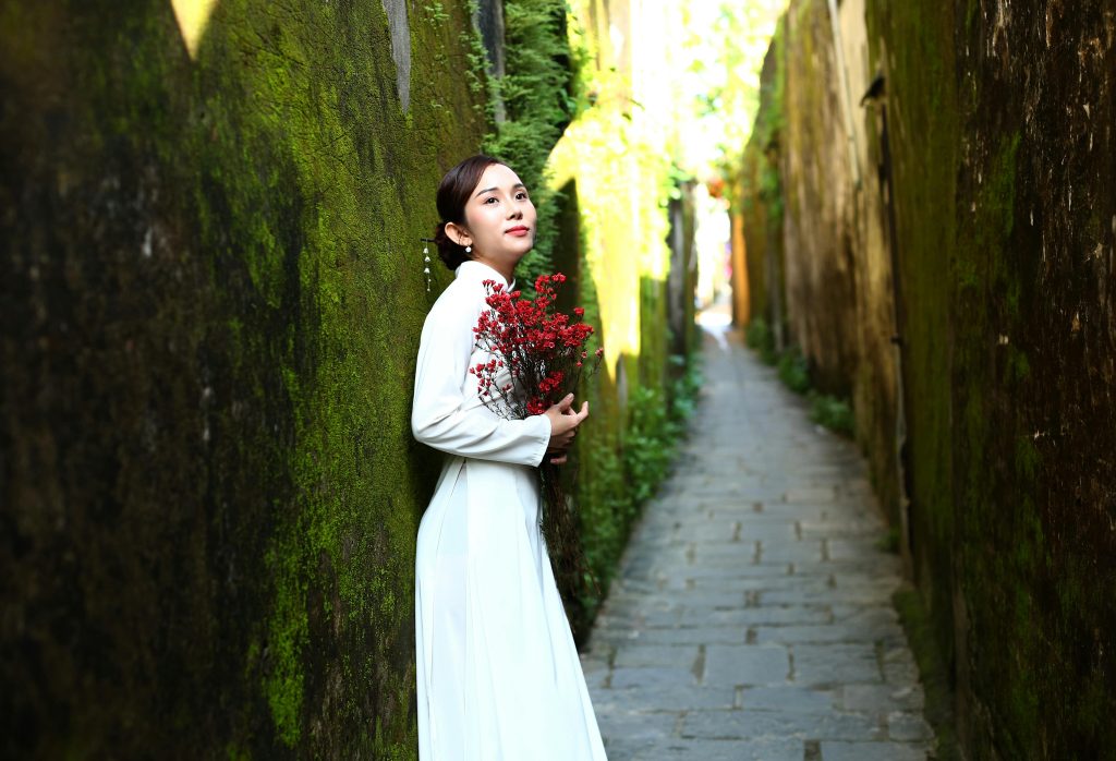 Woman in Traditional Ao Dai in Historic Hội An Alley
