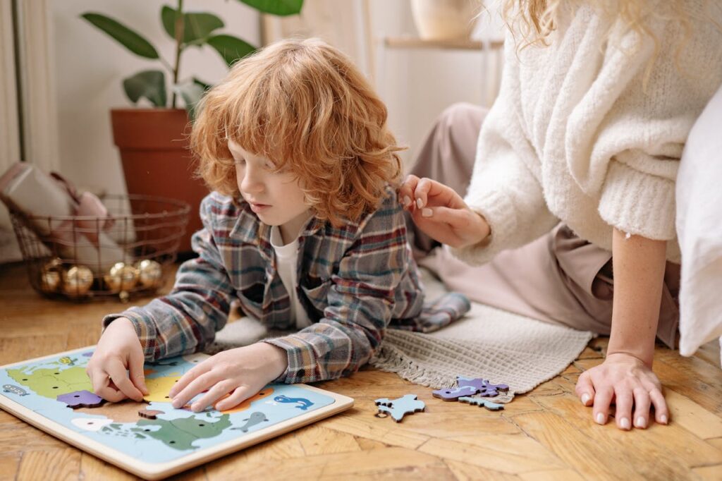 Child Playing Puzzle with Mother at Home
