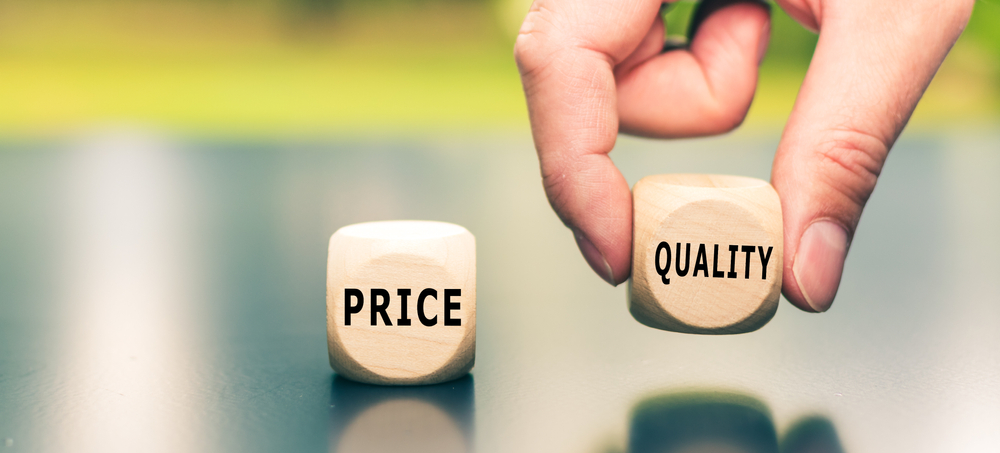 Price versus Quality. The cube with the word "quality" is selected by a hand.