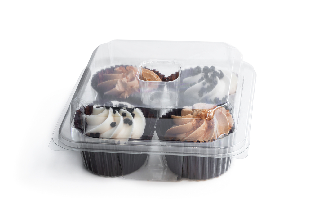 Set of  mini cupcakes in plastic container isolated on white 