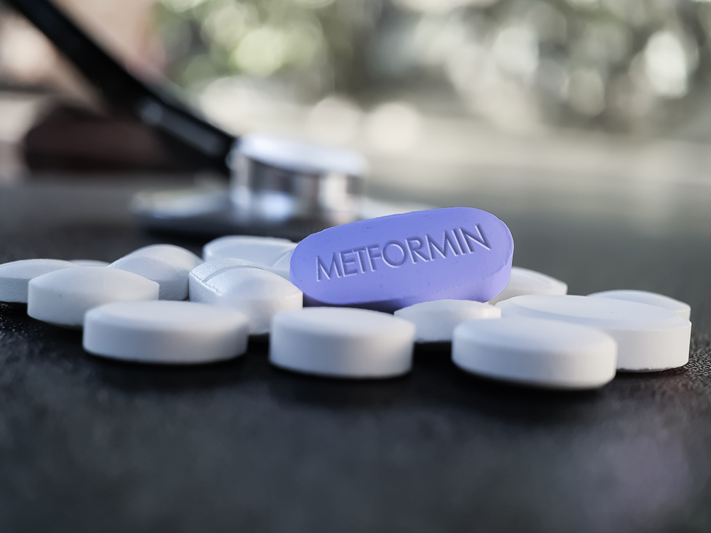 Blue Metformin Pill on Table with stethoscope and other tablets in background. Medicine used in standard oral therapy of type 2 diabetes in people who are overweight High Blood Sugar Treatment
