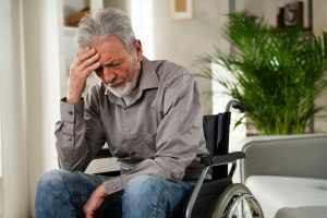 Trump SSI Rule Change Could Cut Disability Benefits for 400K Recipients Disabled elderly man distraught, sitting in wheelchair