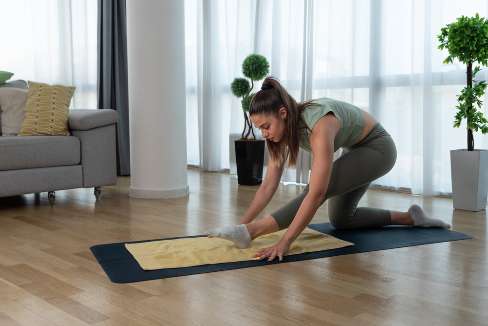Young woman cancer survivor practicing home workout yoga training, stretching muscles and breathing exercise for healthy life after long struggle with sickness and pain.
