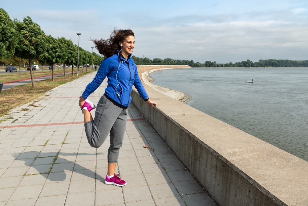 Young woman cancer survivor decides to change her way of life after illness and start practicing every morning as new life routine. Female workout training outdoor for health and happiness.