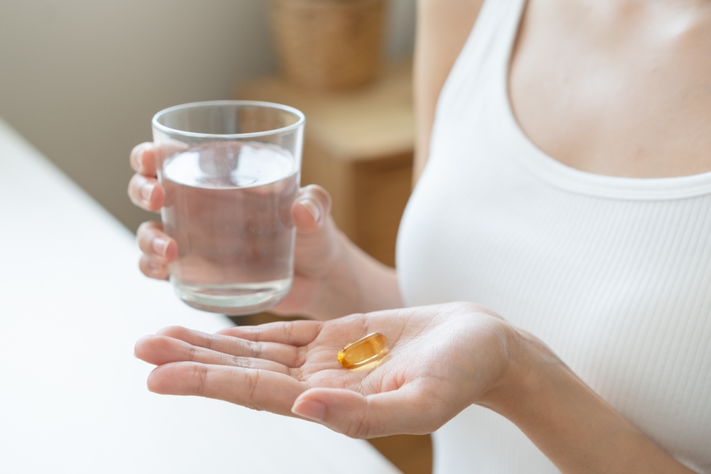 Cultivating Wellness: A Person Embraces the Benefits of Fish Oil Supplements for Optimal Health and Vitality
