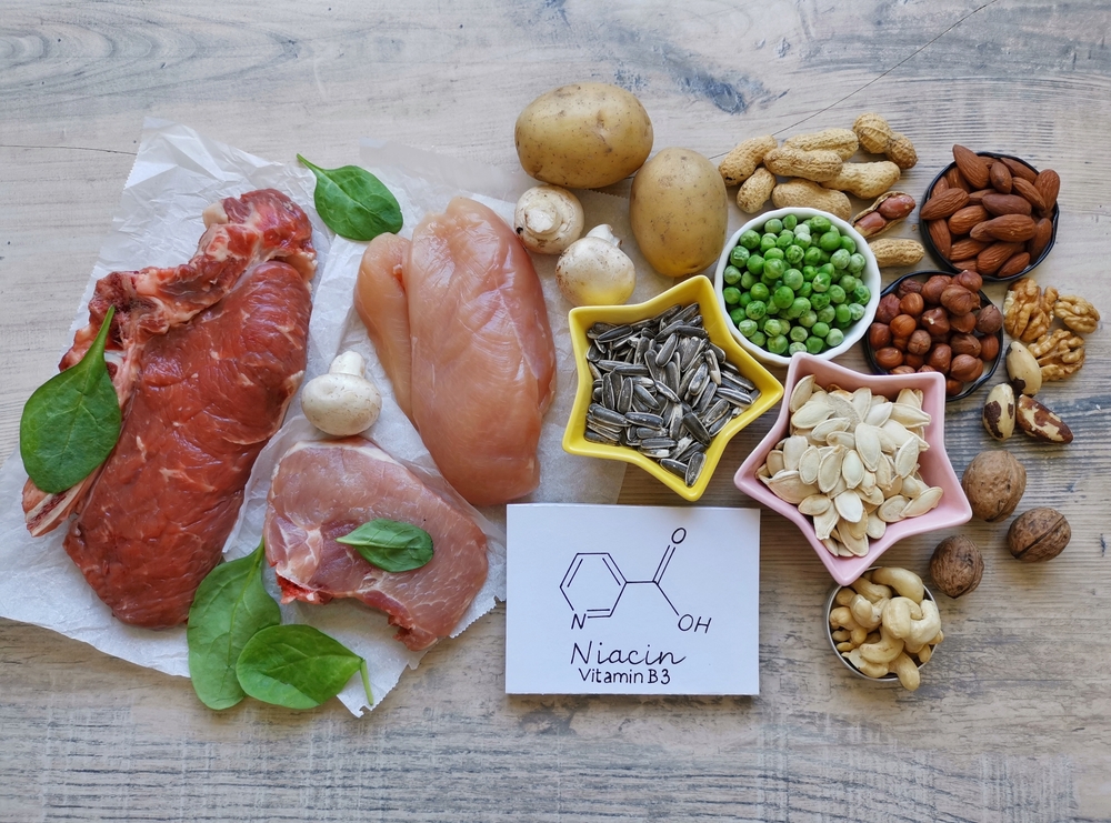 Healthy food rich in vitamin B3 (niacin) with structural chemical formula of niacin. Natural food sources of vitamin B3: seeds,nuts, meat, legumes, mushroom, peanuts. Healthy diet eating.