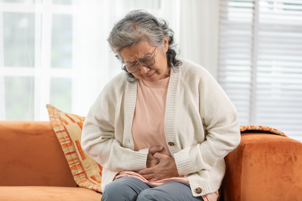 Asian Elderly senior woman stomach ache so pain illness,food poisoning in patient have a bacteria infection,Unhappy elderly painful on stomach vomit and tried need medicine and rest,Elderly Health
