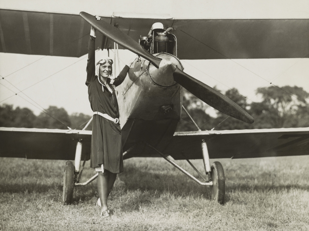 Amelia Earhart, turning the propeller of the sports plane she bought in 1928. The plane was previously owned by Mary, Lady Heath, an Irish aviatrix.